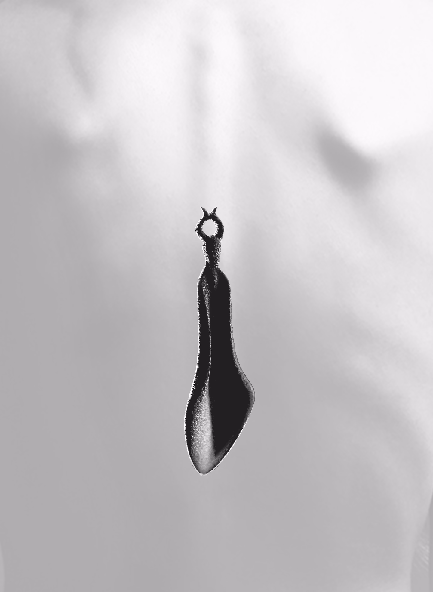 Chaos in black, hanging against a pale bare back