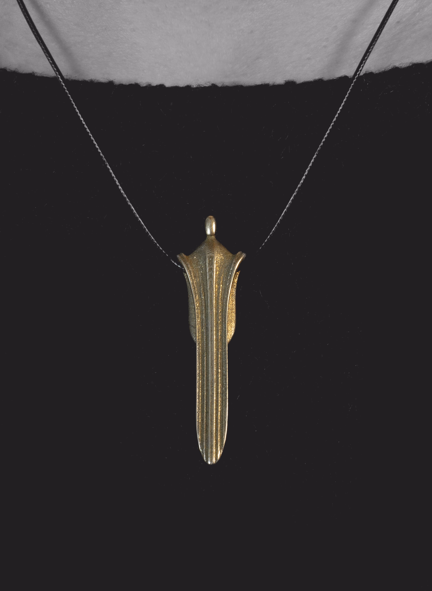 Waterfall hanging still on its cord against a black top