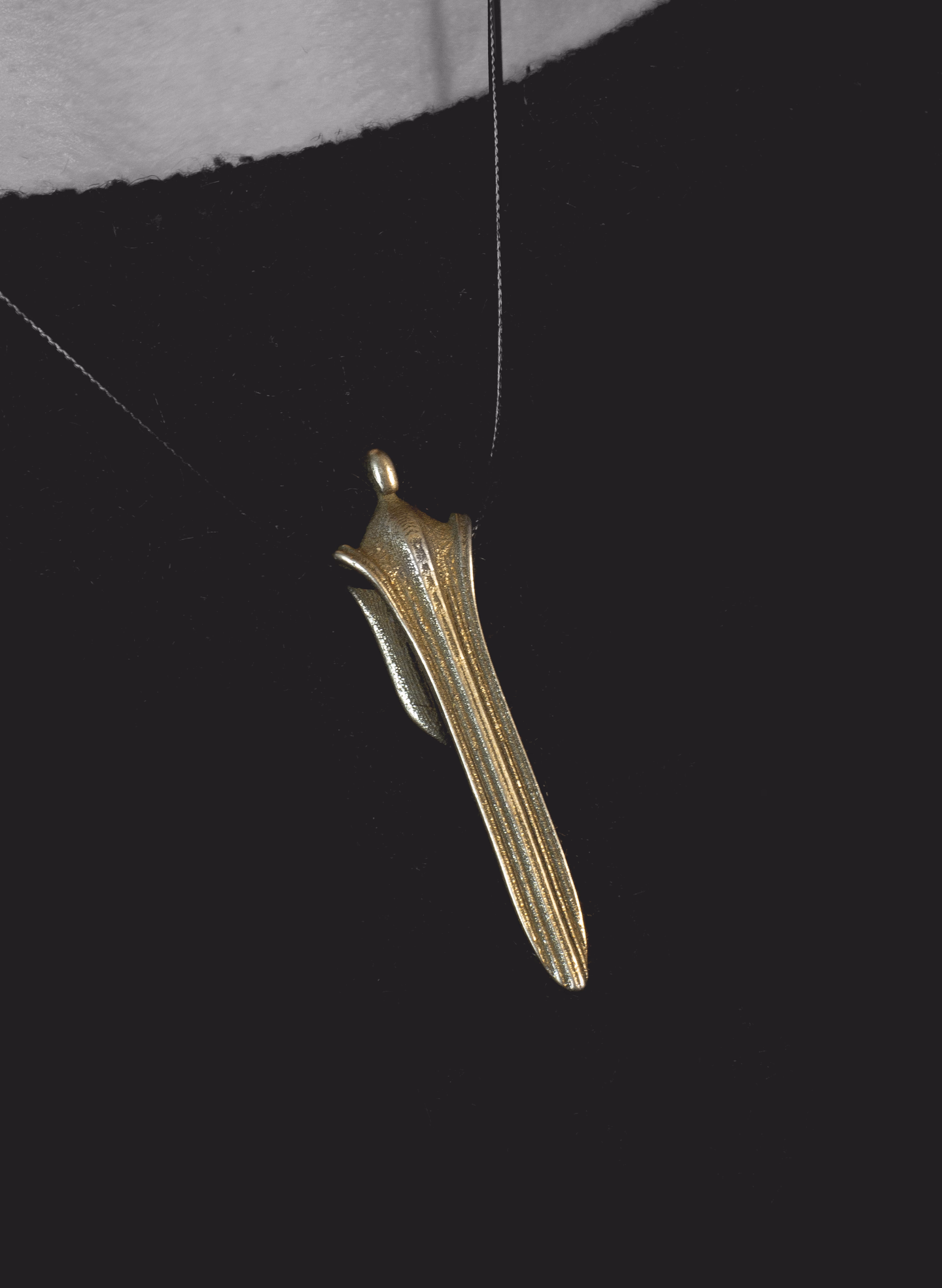 Waterfall swinging on its cord against a black top